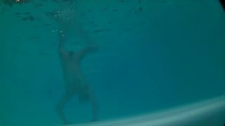 Twink loses trunks in hotel pool and swims naked
